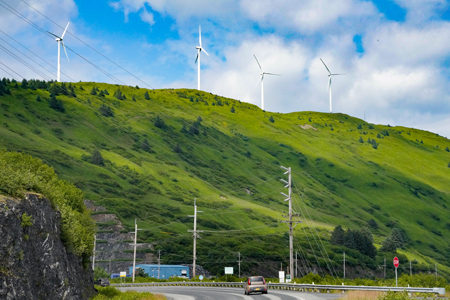 A road and wind turbines on a hill in Kodiak, Alaska